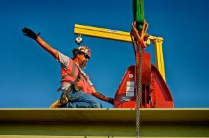 Ironworker Signaling the Crane Operator to Lift a Bridge Beam for The Downtown Span of the Ohio River Bridges Project.